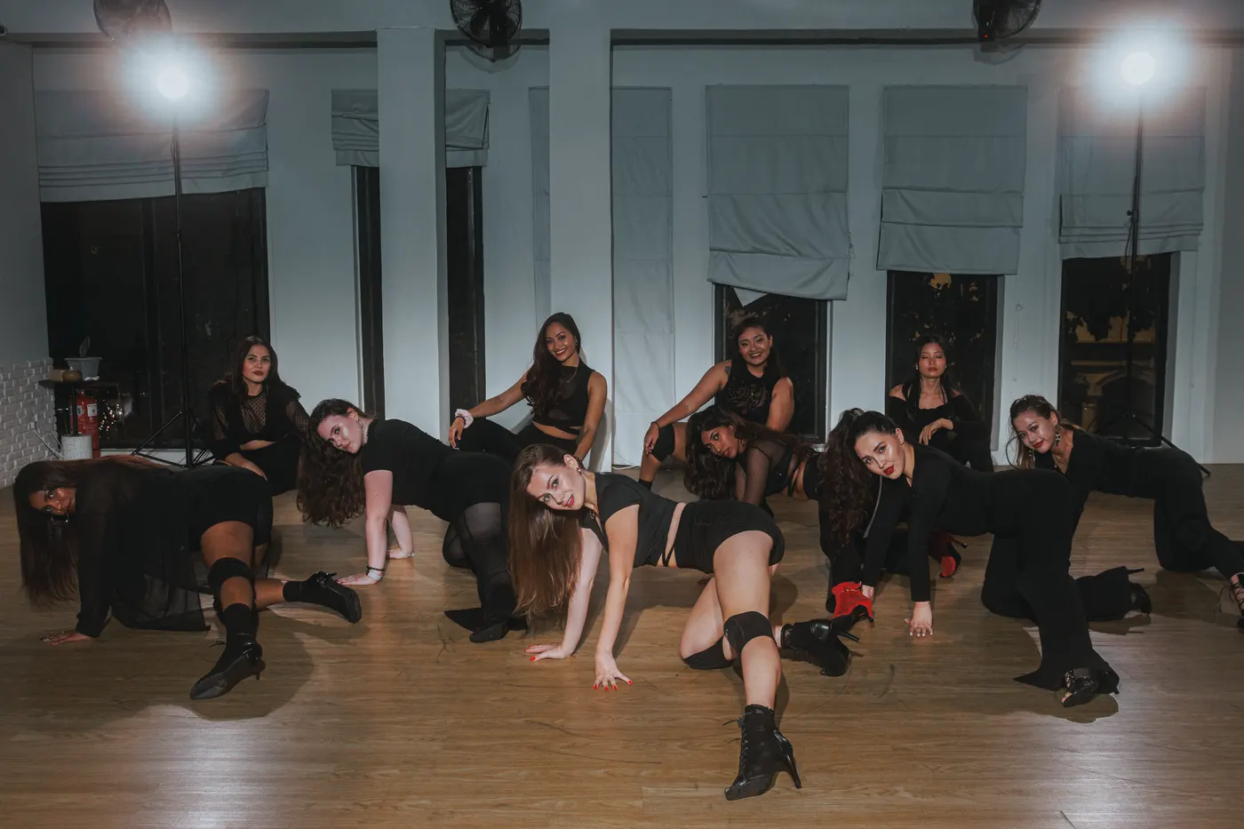 Heels dance group pose on the studio floor